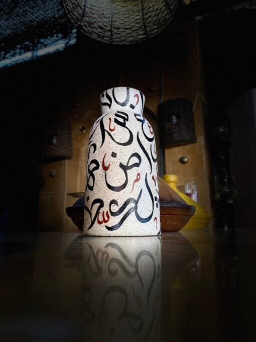 Abstract letters on a ceramic pot