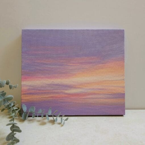 An abstract painting of a sunset sky with yellows, oranges, and pinks peaking through the purple sky to create a beautiful abstract sunset.