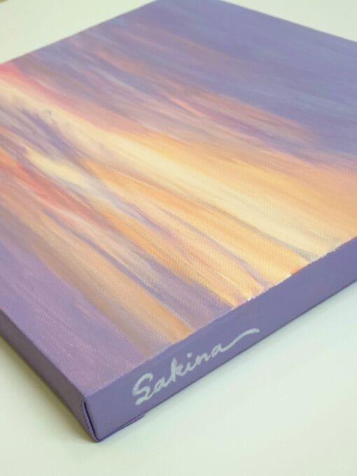 An abstract painting of a sunset sky with yellows, oranges, and pinks peaking through the purple sky to create a beautiful abstract sunset.