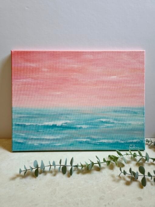 A 30x40 cm abstract seascape acrylic painting featuring beautiful peach sunset sky with the horizon blending softly into the teal waters of the ocean.