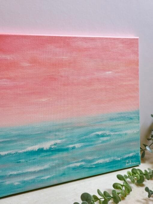 An abstract seascape acrylic painting featuring beautiful peach sunset sky with the horizon blending softly into the teal waters of the ocean.